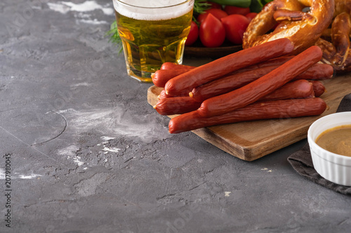 Snack to beer, Bavarian sausages, chips, brezels, crackers and mustard. Oktoberfest food, appetizing beer snacks set for big company. photo