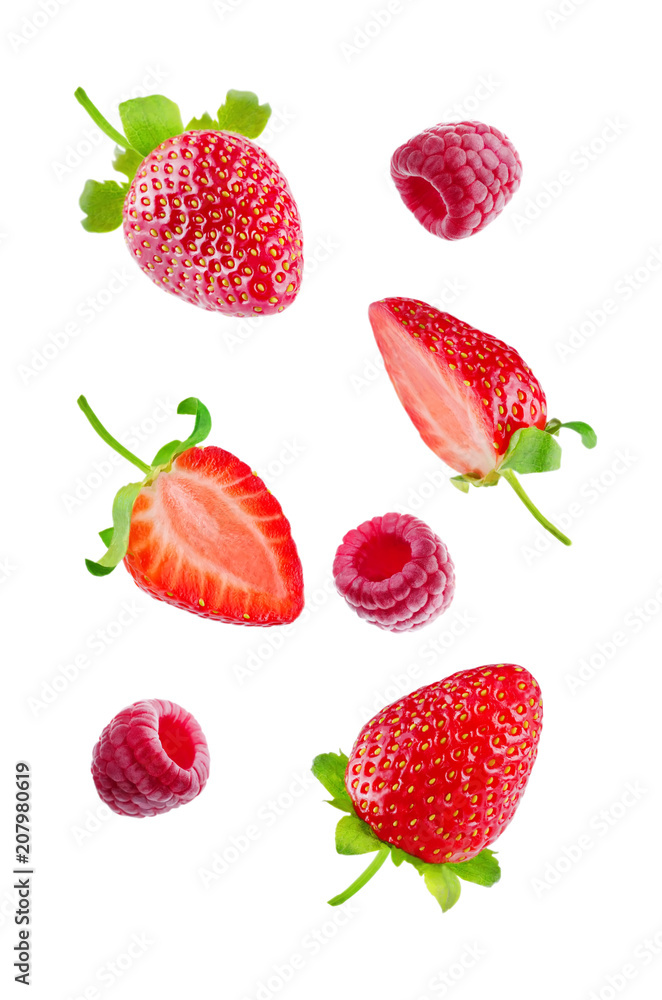 Fresh flying strawberries and raspberries isolated Fresh flying strawberries and raspberries isolated