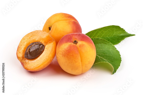 Fresh whole apricot fruit with leaf and half with core, isolated on white background.