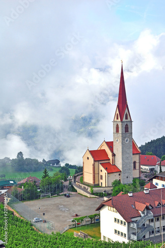 Beautiful church in mountains with clouds on background