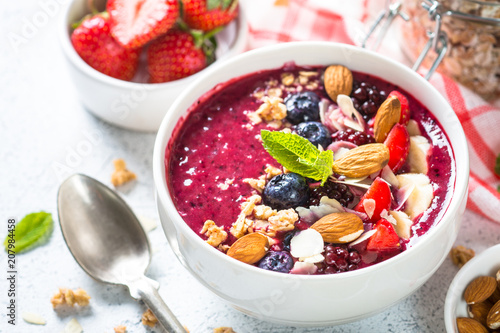 Smoothie bowl from fresh berries, nuts and granola.