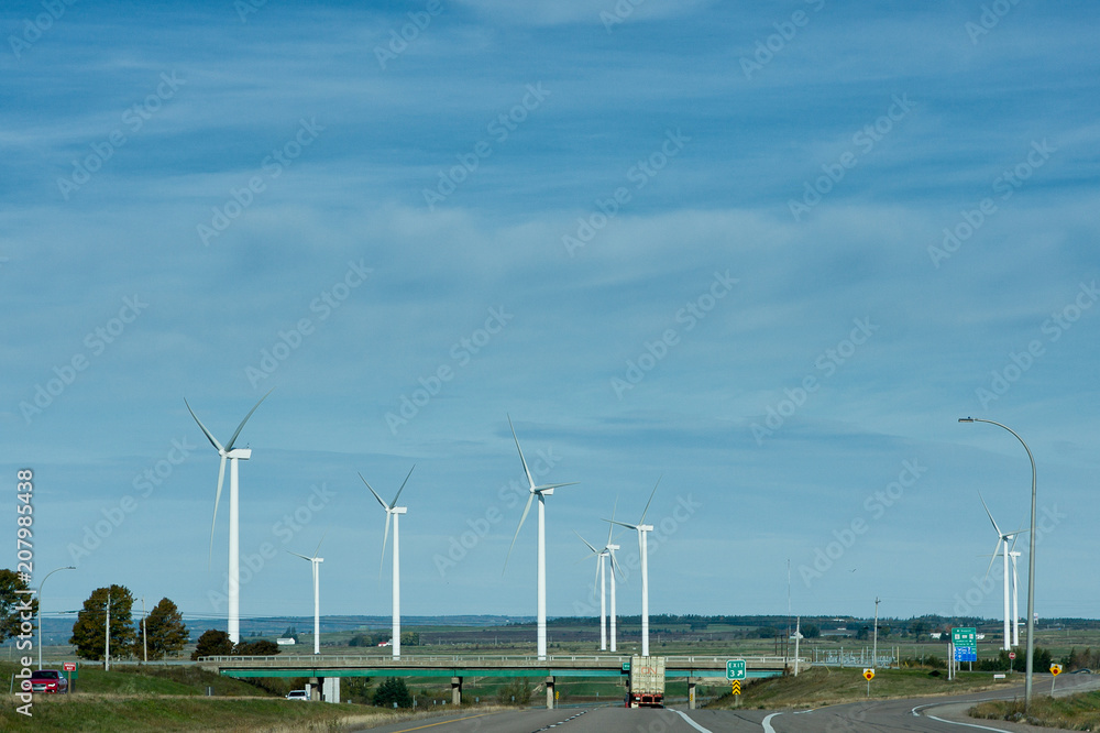Wind turbines near a highway in the summer Wind turbines near a highway in the summer