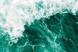 Surreal surface of the sea  waves, splash,  foam and bubbles at high tide and surf, green abstract background