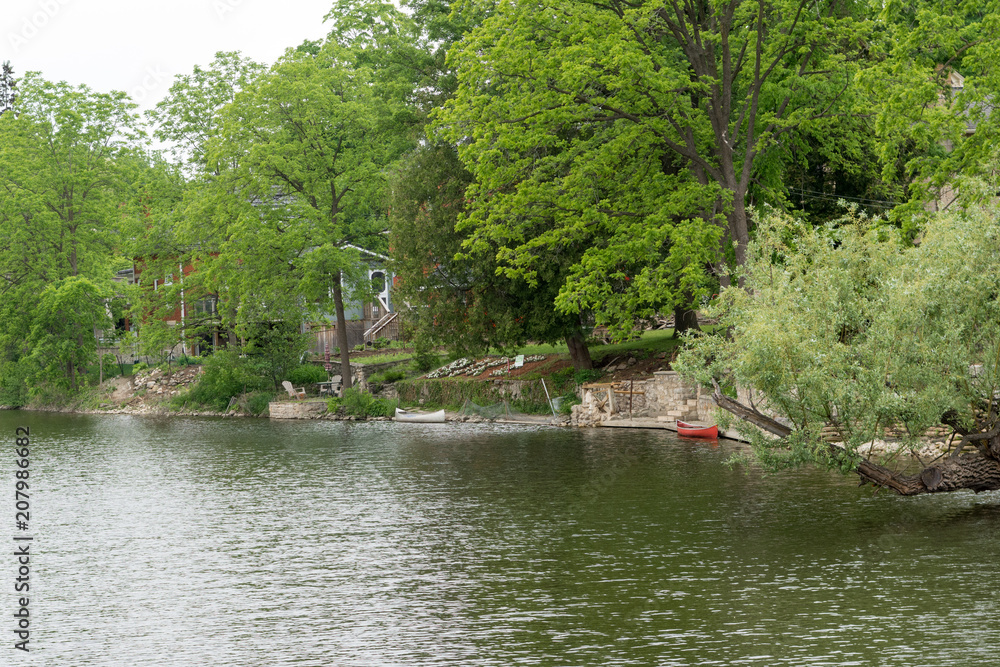 Two canoes near the house on the river Two canoes near the house on the river
