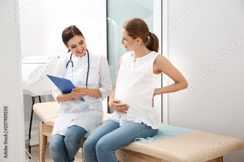 Pregnant woman having appointment at gynecologist office