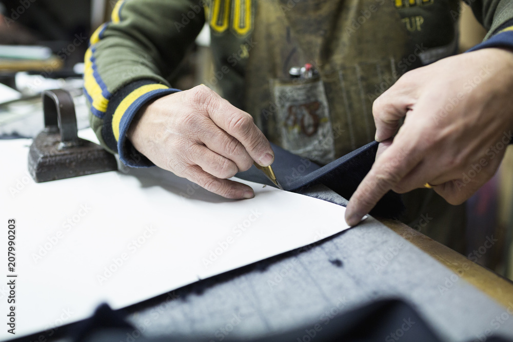 Craftsman cutting leather Craftsman cutting leather
