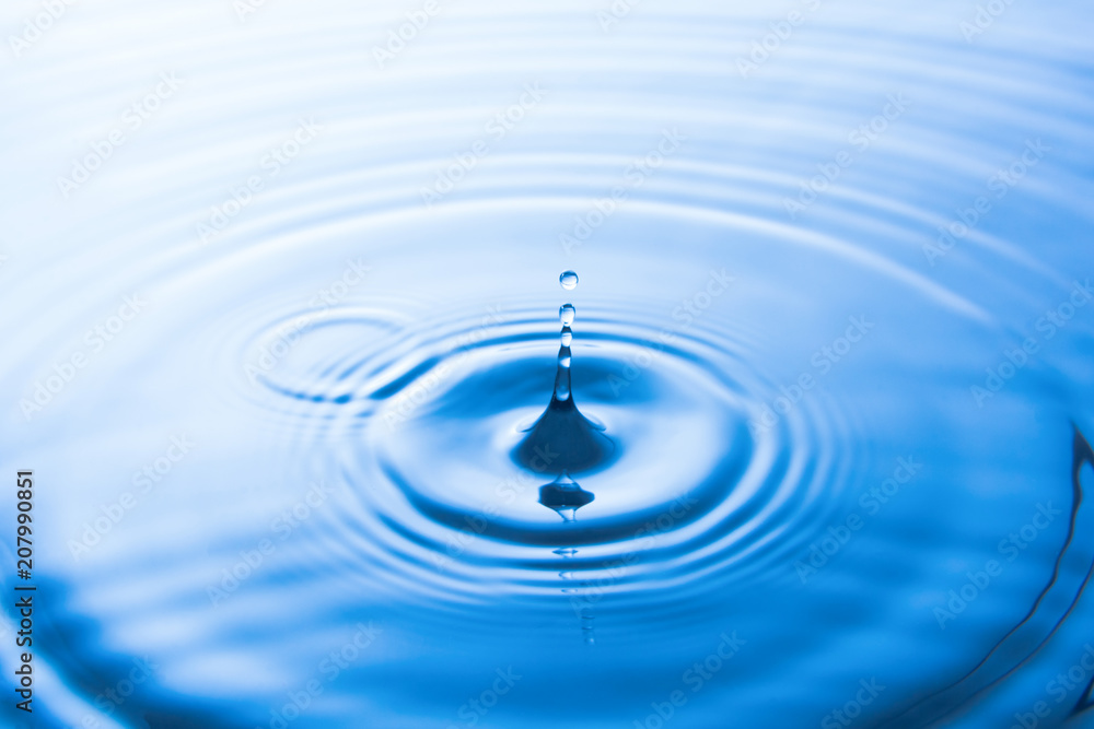 Water drop falling into water make waves. Water splash or water drop background. Water drop falling into water make waves. Water splash or water drop background.