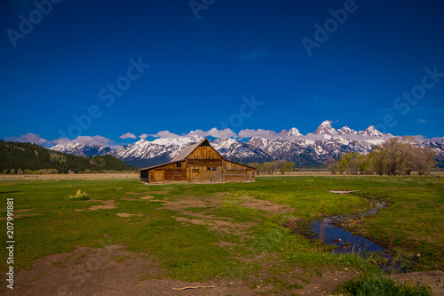 Old mormon barn in Grand Teton Mountains with low clouds. Grand Teton National Park  Wyoming