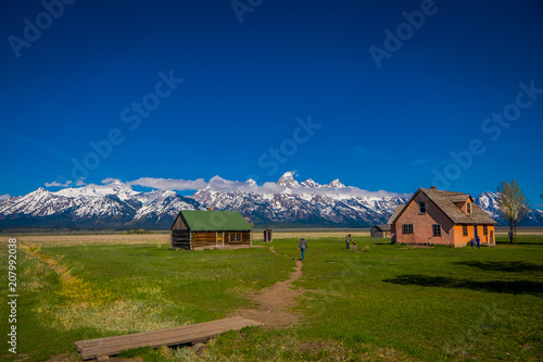 Old mormon barn in Grand Teton Mountains with low clouds. Grand Teton National Park, Wyoming photo