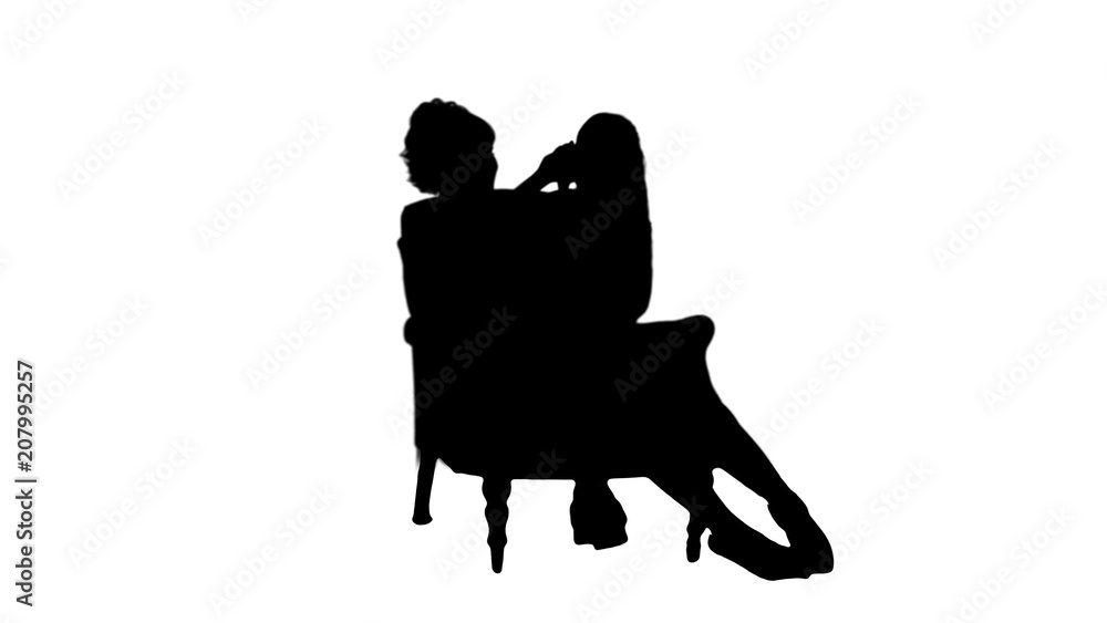 Silhouette Cute little girl sitting in her mother lap while talking on a cell phone track matte