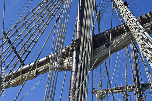 Vintage tall ship mast and rope rigging, blue sky