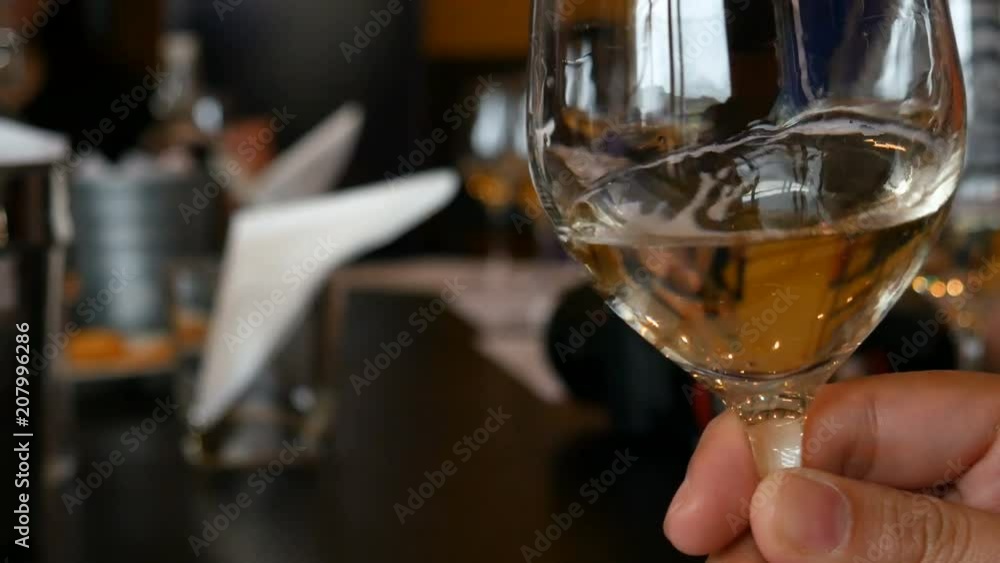 Man holding glasses of white wine at restaurant. Man holding glasses of white wine at restaurant.