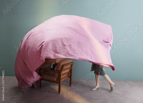 woman playing with pink sheet