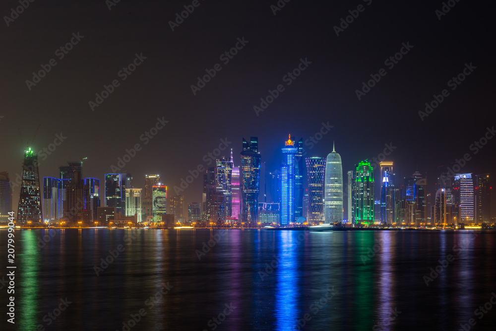 doha night city reflecting in water of persian gulf