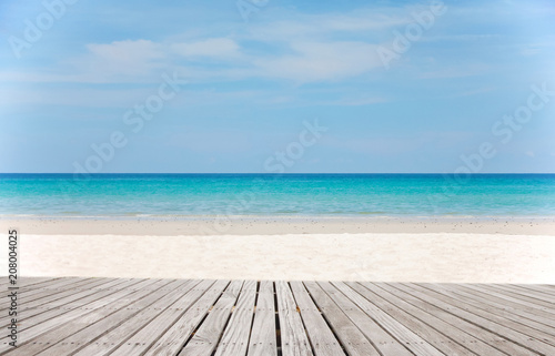 Fototapeta Old empty wooden pier perspective with sandy beach