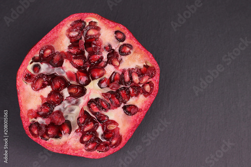 Tableau sur toile Garnet fruit in detail in grey background