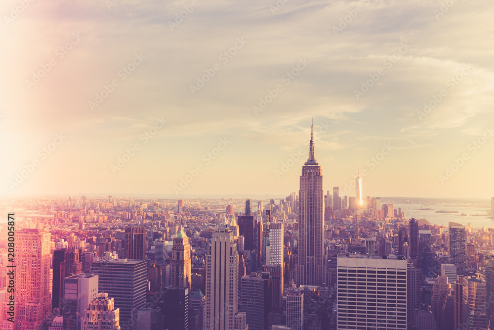 Vintage style image of buildings across New York City at sunset with retro filter 