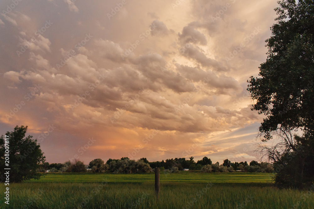 Orange summer sunset over a homestead in Montana. Orange summer sunset over a homestead in Montana.
