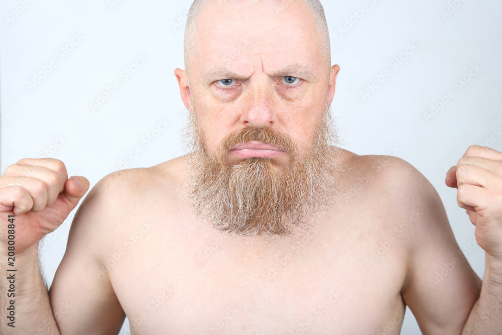 Obraz premium The aggressive bearded man with his fists