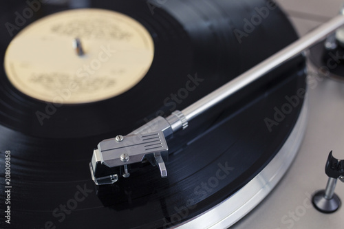 Record Player Tone Arm on a Spinning Vinyl Disc