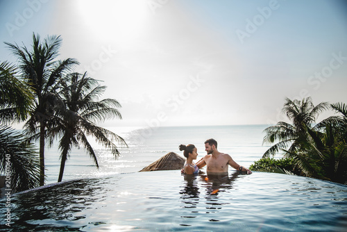 Couple relaxing in swimming pool photo
