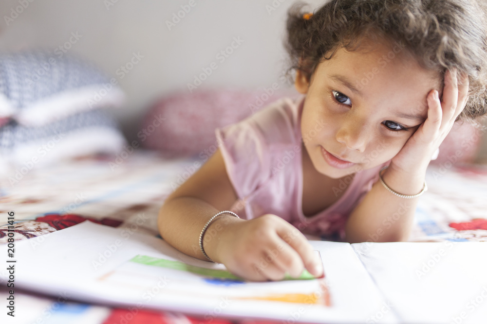 Cute kid making sketch with wax pencils and making fun Cute kid making sketch with wax pencils and making fun