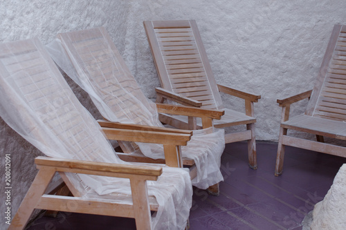 Salt room. interior salt cave wooden chairs and outgrowths of salt photo