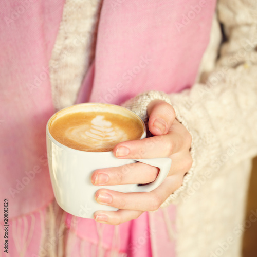 Girl holding a cup of coffee or hot chocolate or chai tea latte. Quiet hygge time concept
