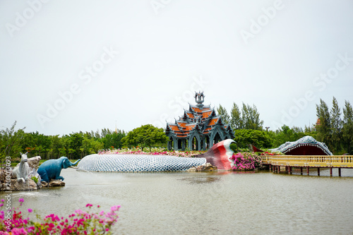 Wallpaper Mural gray wall and orange roof of pavilion in the middle of the pool, with big fish statue in around it, Thailand belief story. Torontodigital.ca