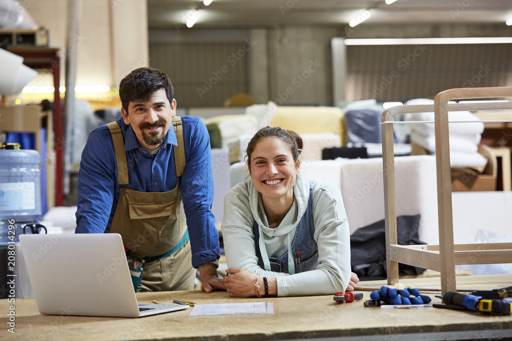Happy Colleagues At Workbench In Sofa Workshop Happy Colleagues At Workbench In Sofa Workshop