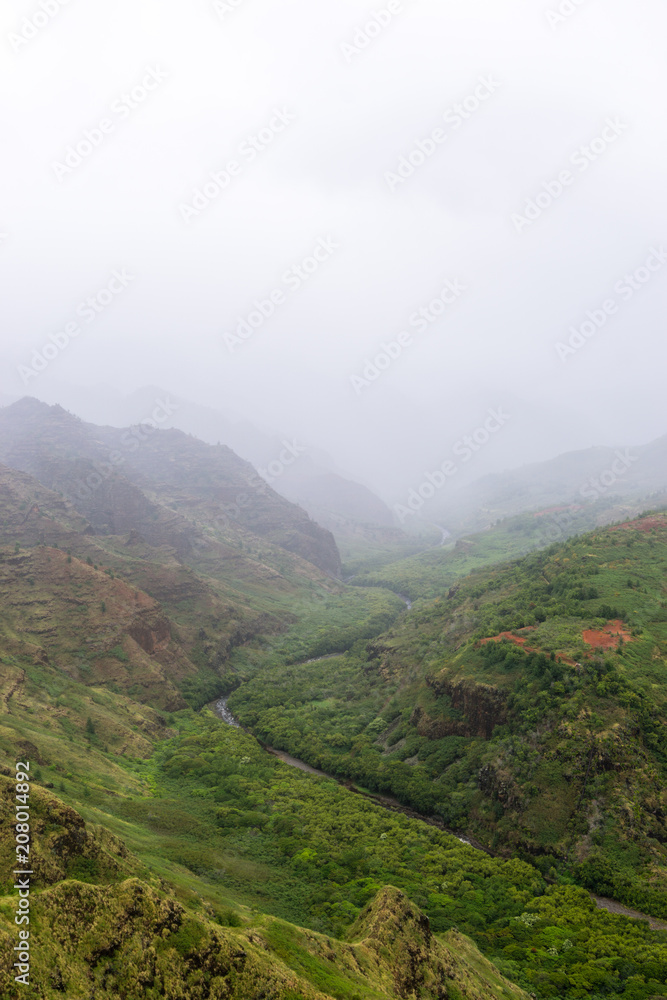 Aerial view on a foggy overcast day over Waimea Canyon in Kauai, Hawaii - also known as The Grand Canyon of the Pacific