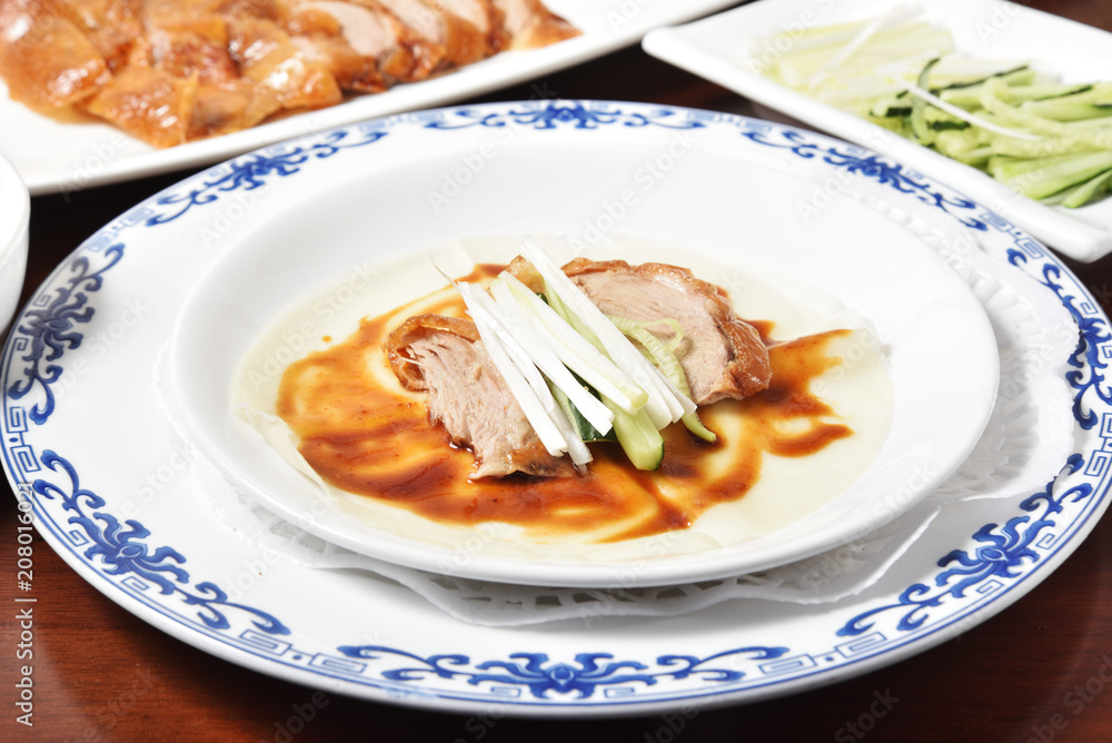 Peking Duck - Chinese roast duck served with spring onion and hoisin sauce, wrapped in pancakes. Peking Duck - Chinese roast duck served with spring onion and hoisin sauce, wrapped in pancakes.