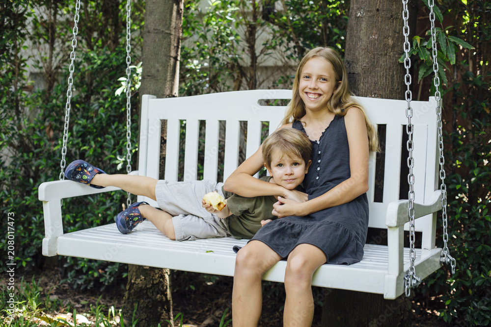 Brother and sister on swing Stock Photo | Adobe Stock