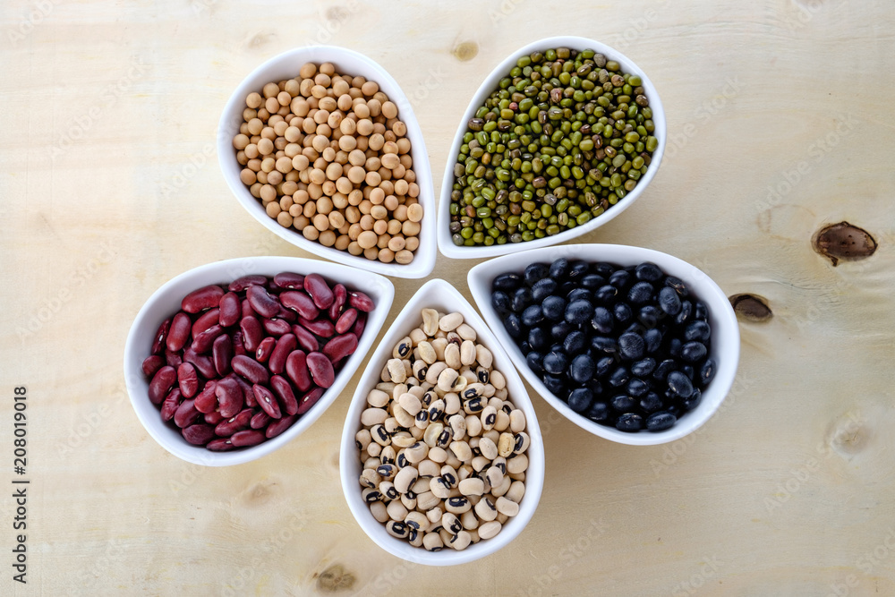 Healthy food, variety of beans. Mung beans black beans , soybean, red kidney , black eye peas on white ceramic bowl.