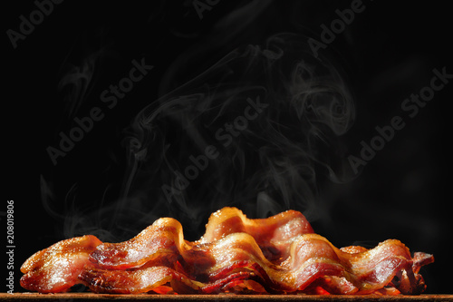 Pile of Sizzling Bacon Isolated on Black photo