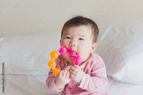 Cute baby holding teething ring