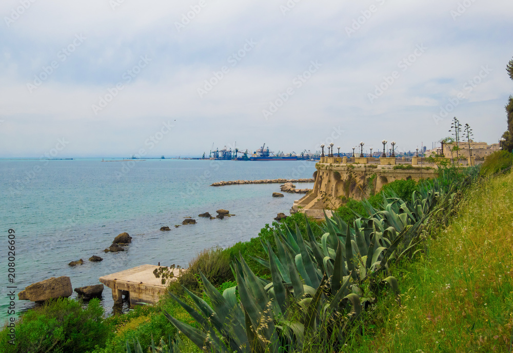 Taranto, Italy - The historic center of a big city in southern Italy, on the sea with industry port, in a spring day. Taranto, Italy - The historic center of a big city in southern Italy, on the sea with industry port, in a spring day.