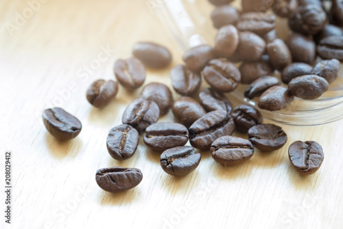 Coffee beans with copy space for text on wood background.