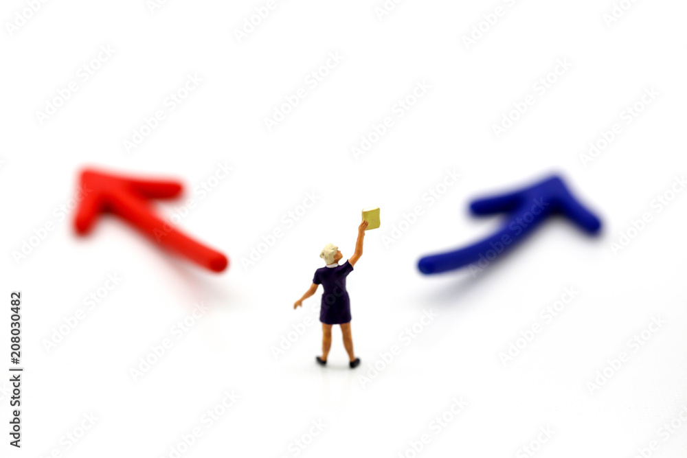 Fototapeta premium Miniature people : women reading a book with arrow.