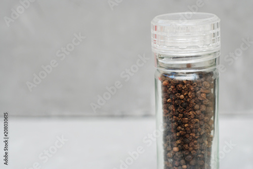 Peppercorn Whole Black Pepper Spices over Gray Textured Background. Food Ingredient.