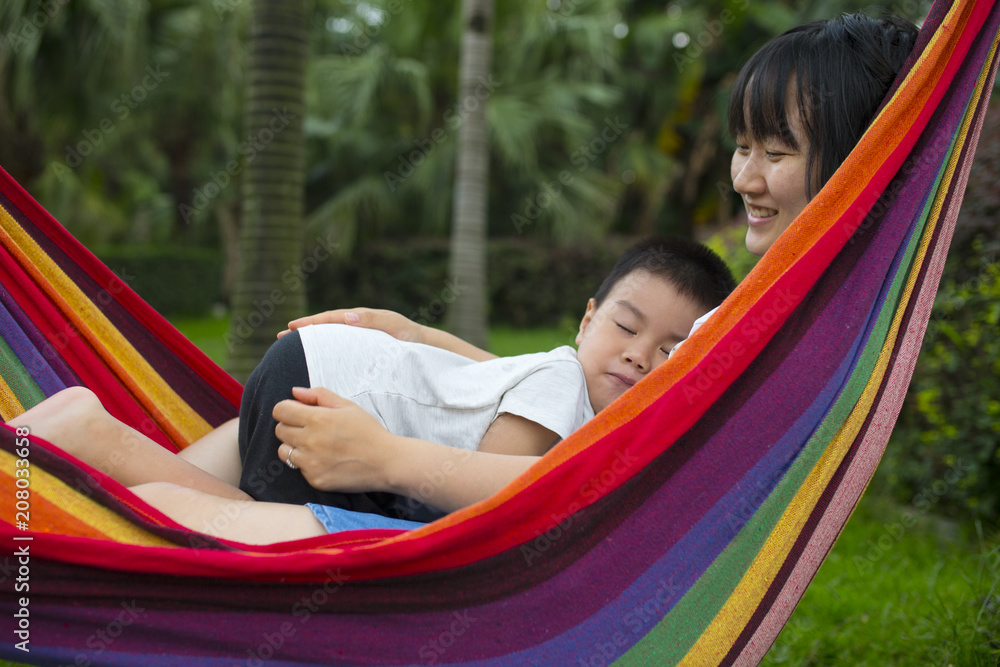 little boy with her mother in the  hammock