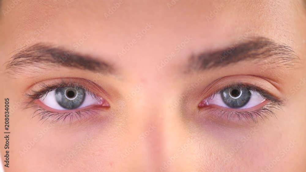 Beautiful female blue eyes closeup. Young woman eyes blinking and looking up. 4K UHD video 3840X2160 Beautiful female blue eyes closeup. Young woman eyes blinking and looking up. 4K UHD video 3840X2160