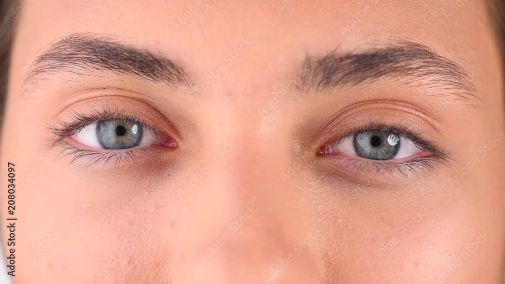 Beautiful female blue eyes closeup. Young woman eyes blinking and looking up. 4K UHD video 3840X2160 Beautiful female blue eyes closeup. Young woman eyes blinking and looking up. 4K UHD video 3840X2160