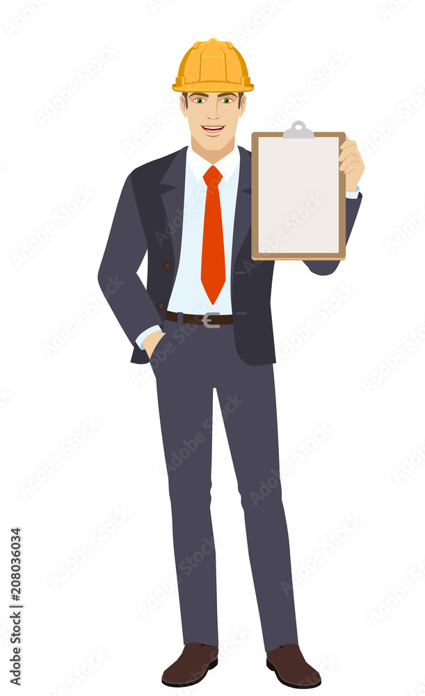 Businessman in construction helmet with hand in pocket holding clipboard Businessman in construction helmet with hand in pocket holding clipboard