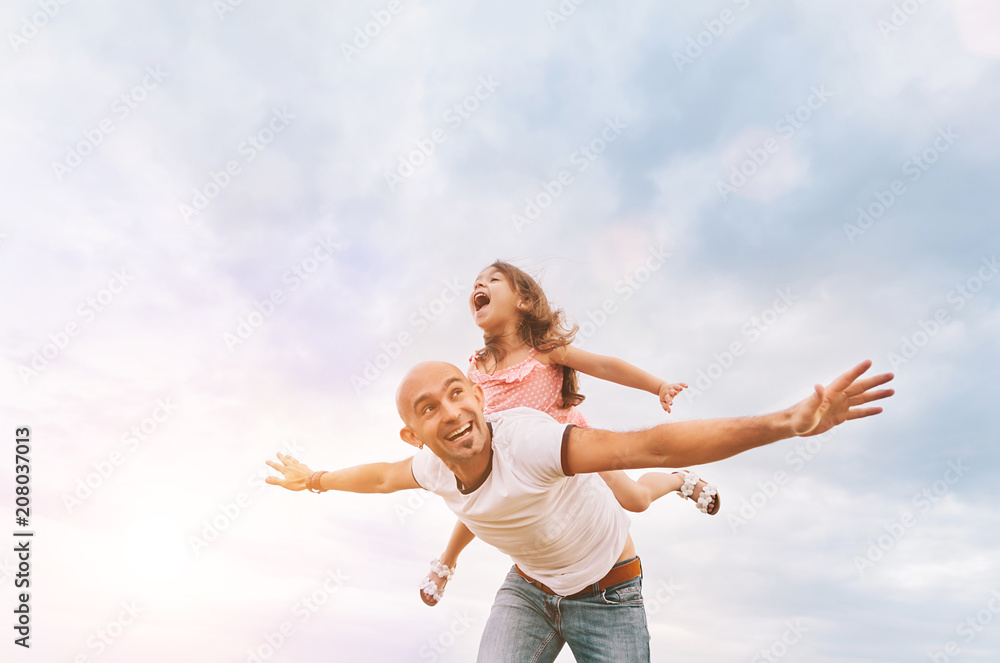 Fathrer and cute daughter playing like airplane Fathrer and cute daughter playing like airplane