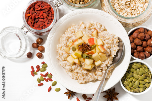 oatmeal with apples, dried fruit and nuts, top view