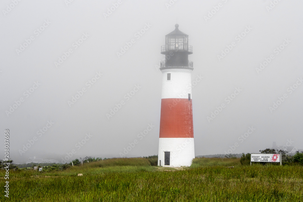 Nantucket, Massachusetts. The Sankaty Head Light, a White with red band midway lighthouse built in brick and granite in 1850 near the village of Siasconset in Nantucket island