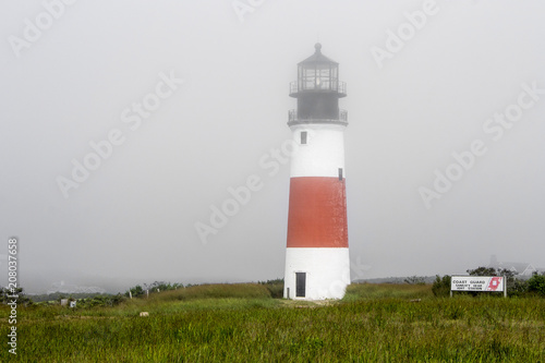 Nantucket, Massachusetts. The Sankaty Head Light, a White with red band midway lighthouse built in brick and granite in 1850 near the village of Siasconset in Nantucket island