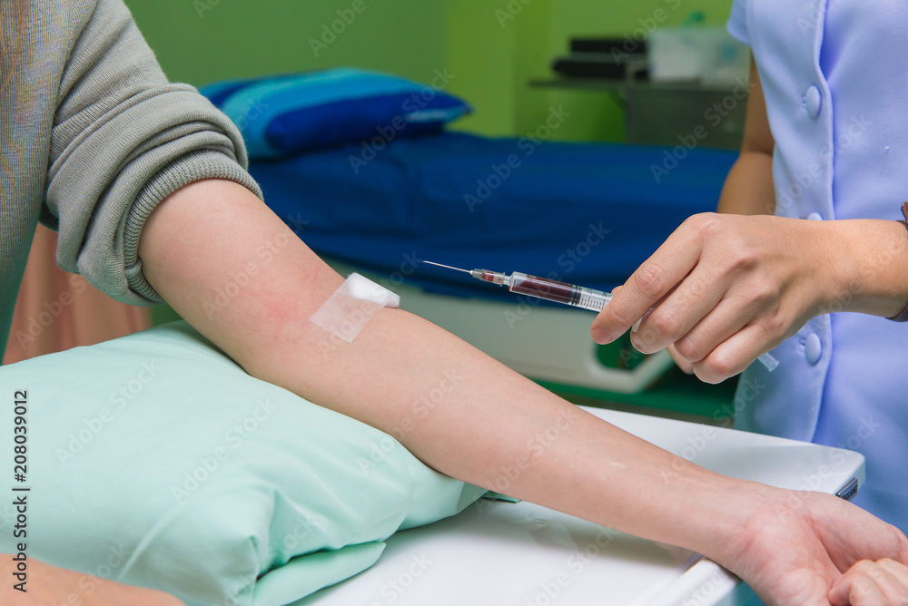 Nurse collecting a blood from patient in hospital Nurse collecting a blood from patient in hospital