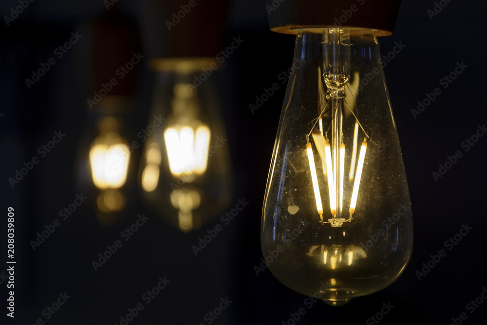 Vintage light bulb close up, lighting bulb in the dark.
